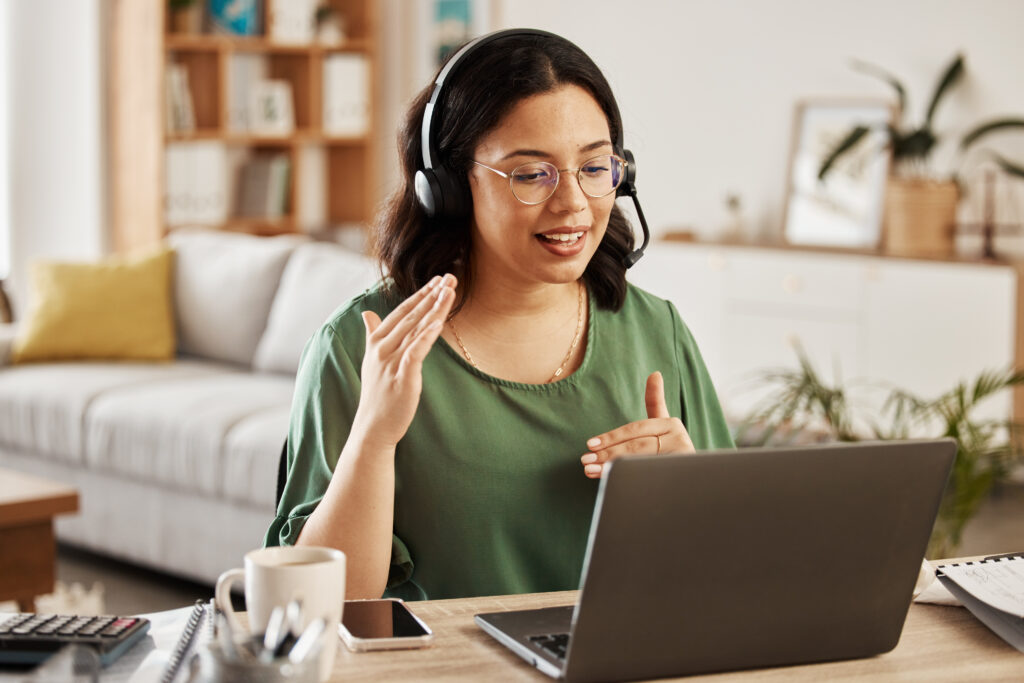 Healthcare professional on a video call with headset working remotely from home, empowering collaborative consultations and flexible healthcare career opportunities.